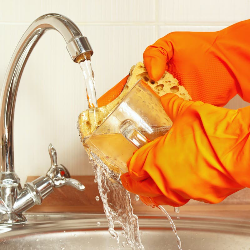 Hands in Gloves Wash the Glass Under Running Water in Kitchen Stock