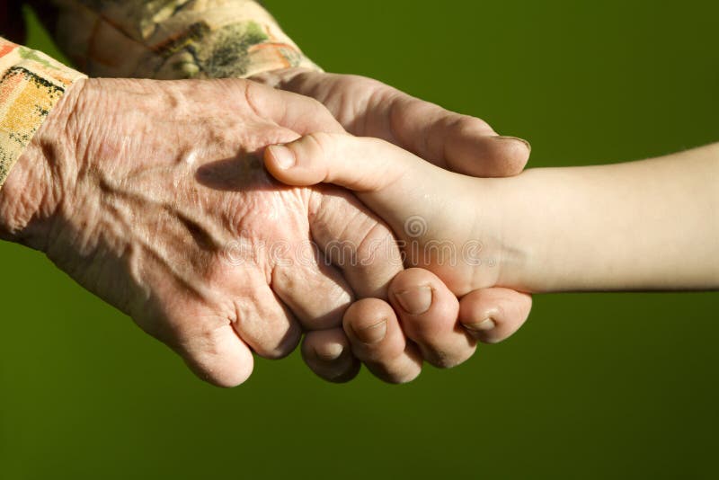 Hands of grandmother and grandchild