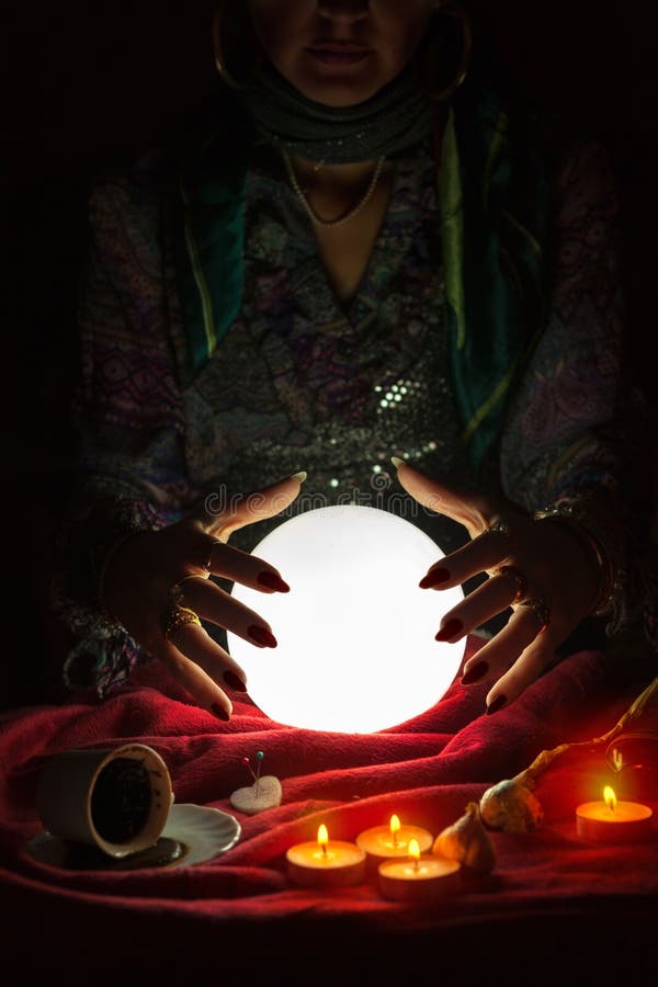 Hands from Gypsy Fortune Teller Above Magic Crystal Ball Stock Photo