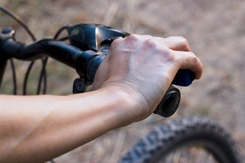 Hands on handlebar bicycle on nature background