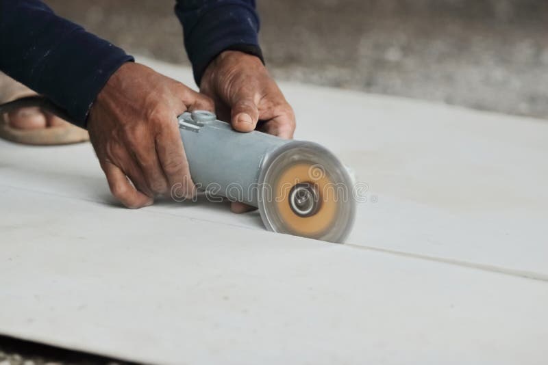 Hands of Heavy Industry Worker with Angle Grinder Cutting Concrete