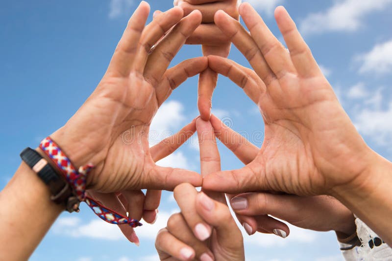 Youth culture, gesture and people concept - close up of hippie friends showing peace hand sign over blue sky and clouds background. Youth culture, gesture and people concept - close up of hippie friends showing peace hand sign over blue sky and clouds background