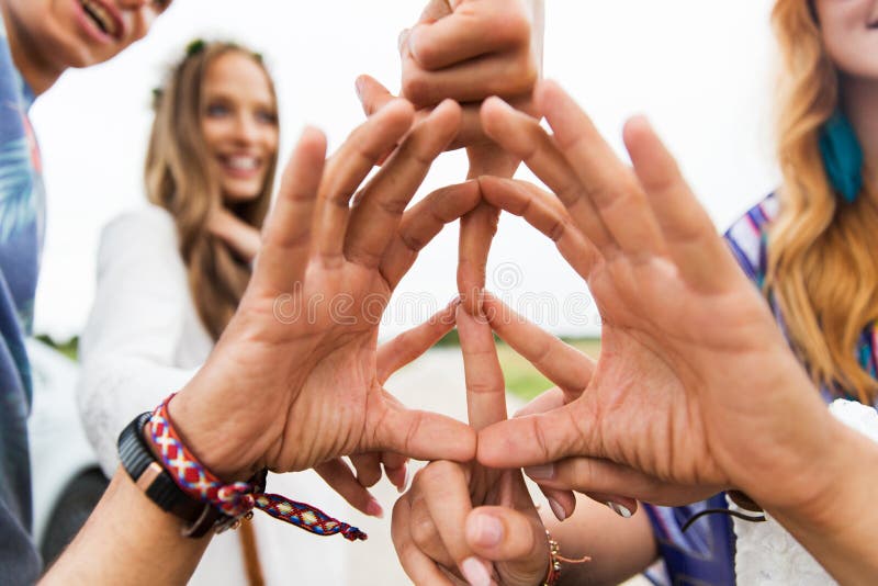 Youth culture, gesture and people concept - close up of hippie friends showing peace hand sign outdoors. Youth culture, gesture and people concept - close up of hippie friends showing peace hand sign outdoors