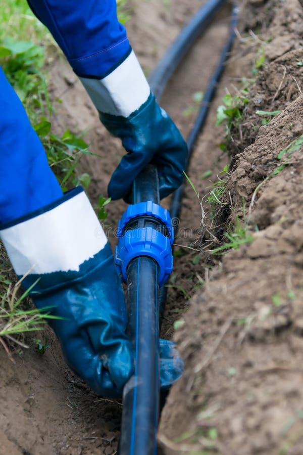 Hands Hold Black Pipe before Laying in the Ground Stock Image Image