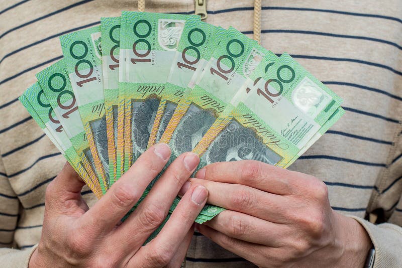 Hands holding australian dollars 100 banknotes. Finance and payment stock photography