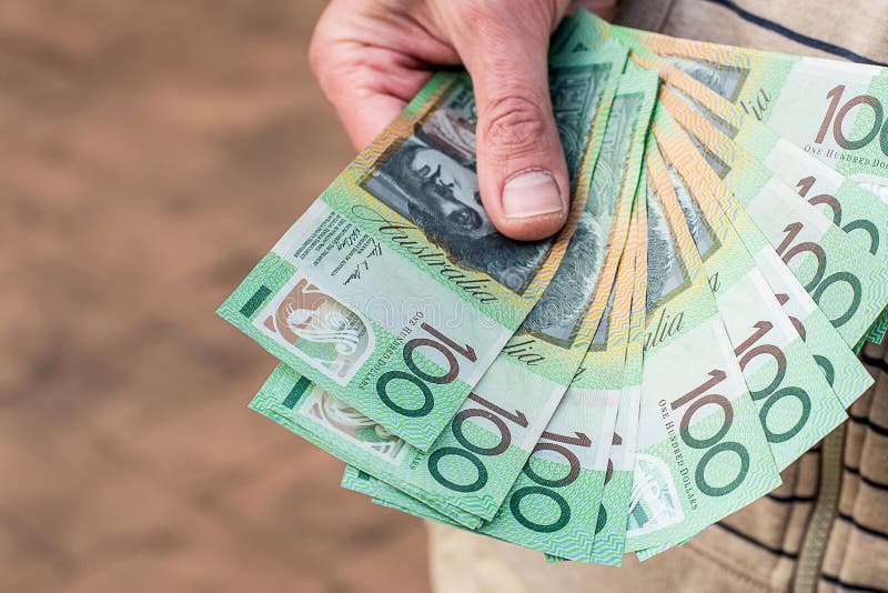 Hands holding australian dollars 100 banknotes. Finance and payment stock photos