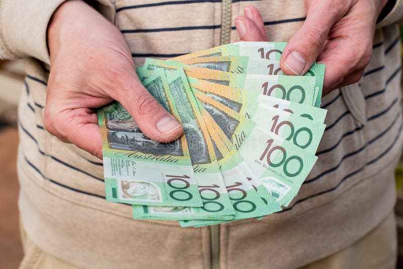 Hands holding australian dollars 100 banknotes. Finance and payment stock photo