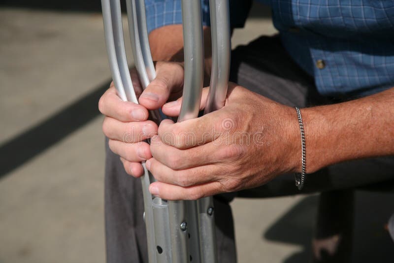 Hands holding crutches stock image. Image of fracture 1572479