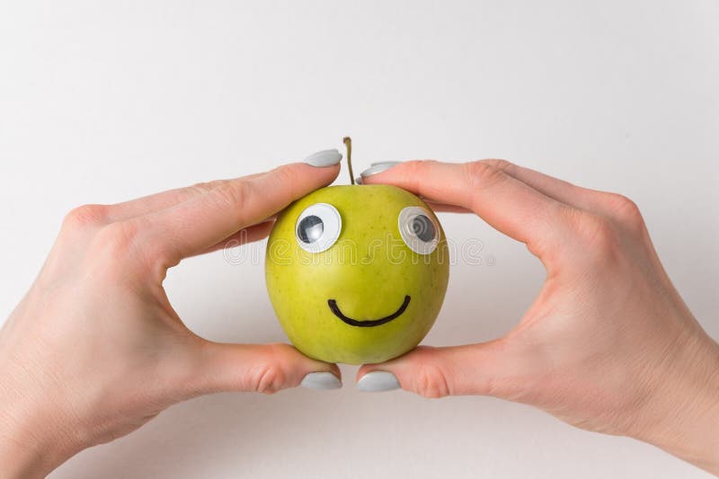 Cute Apple with Funny Face on White Background. Green Apple with Googly