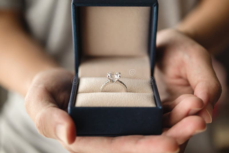 Hands Holding Diamond Ring in Jewelry Box Stock Image Image of