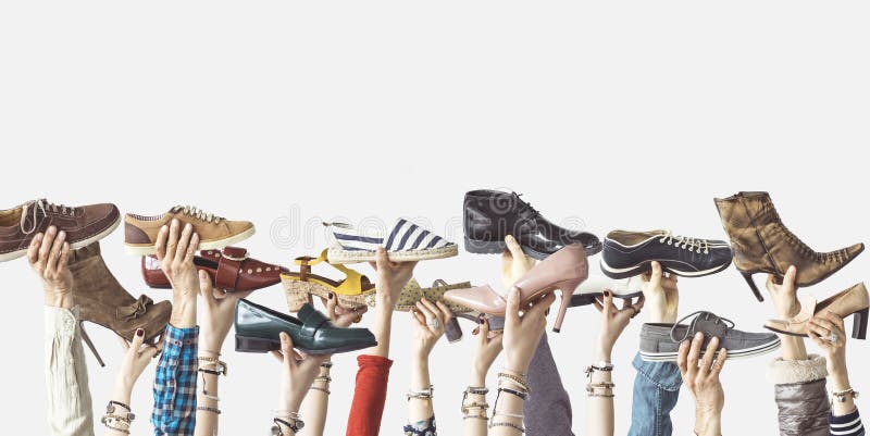 Hands holding different shoes on isolated background stock photos