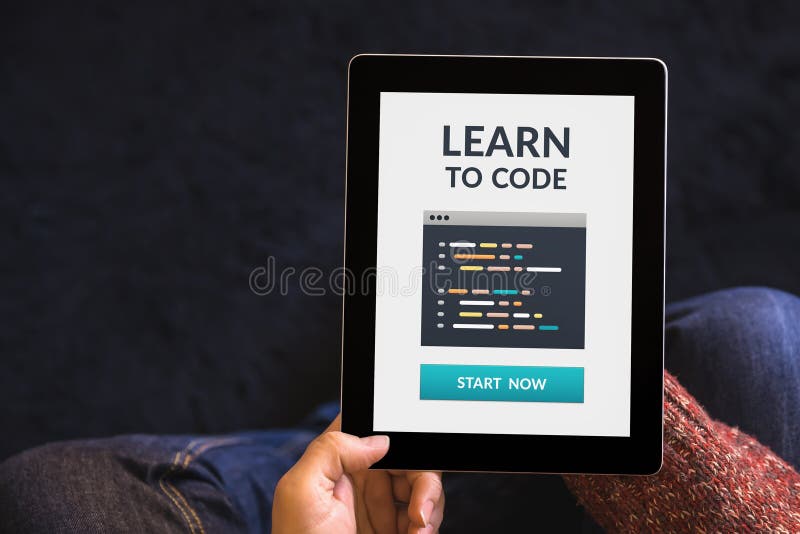 Hands holding tablet with learn to code concept on screen royalty free stock photos