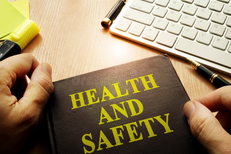 Hands holding documents with title health and safety. royalty free stock images