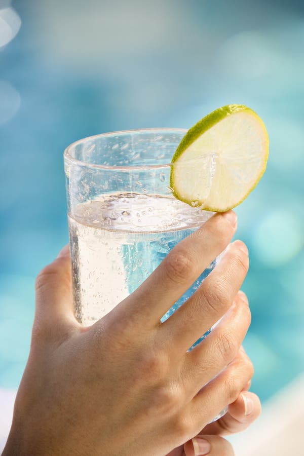 Hands holding drink glass. stock image. Image of adult 3181585