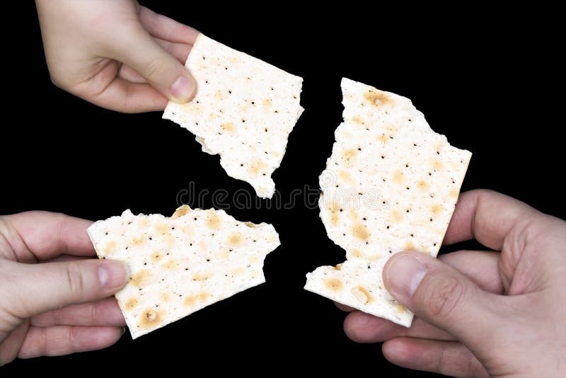 Hands holding matzah for jewish passover. An overhead photo of Jewish child, woman and men hands hold matza, leavened bread isolat stock photos Hands holding matzah for jewish passover. An overhead photo of Jewish child, woman and men hands hold matza, leavened bread isolat stock photos
