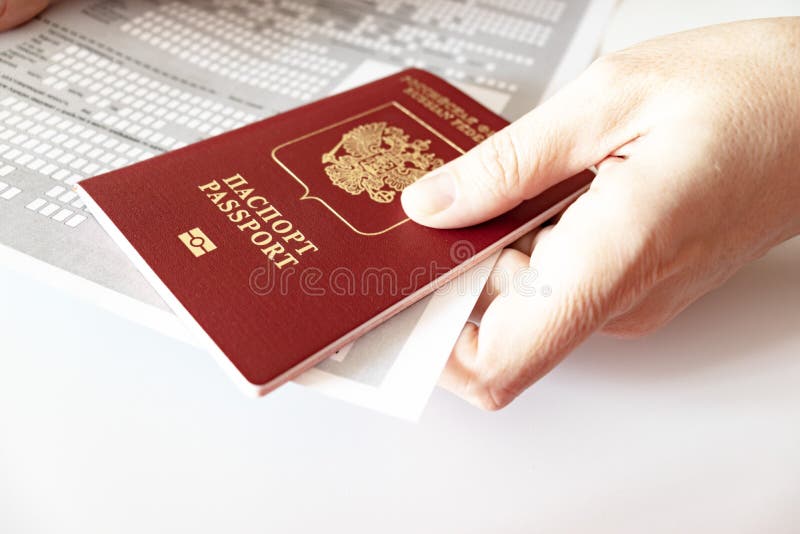 Hands holding russian passport and registration at the place of stay form royalty free stock images Hands holding russian passport and registration at the place of stay form royalty free stock images