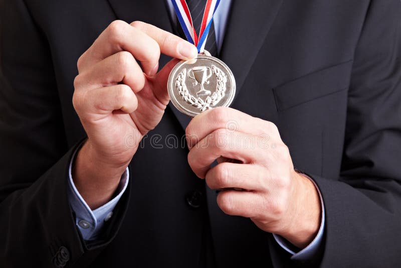 Hands holding silver medal