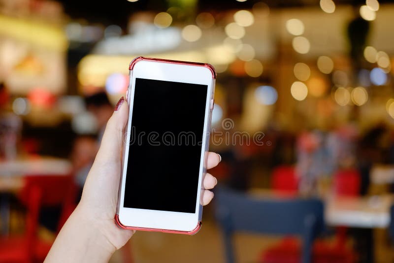 Hands holding smartphone empty display mockup mobile with cafe. stock photos Hands holding smartphone empty display mockup mobile with cafe. stock photos