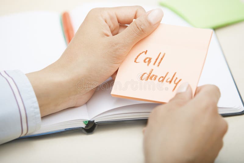 Call daddy text on adhesive note royalty free stock images