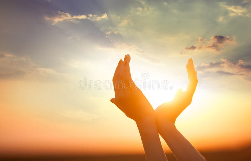Hands holding the sun stock image