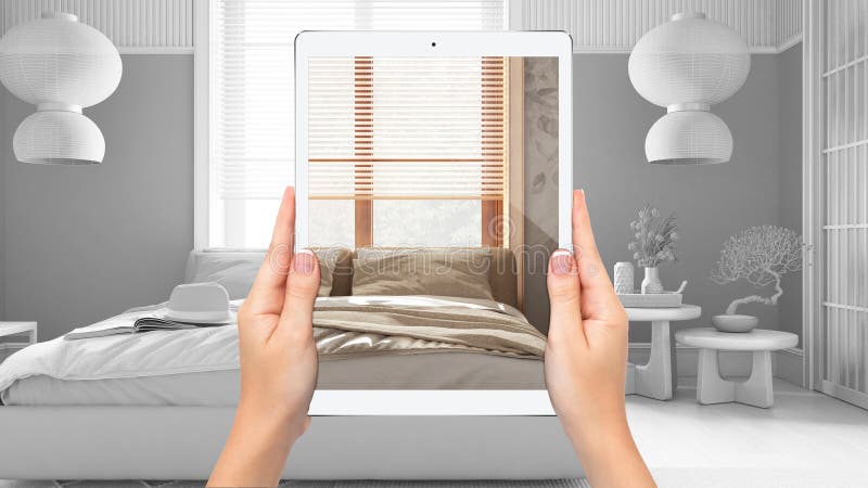 Hands holding tablet showing wooden japandi bedroom, total blank project background, augmented reality concept, application to simulate furniture and interior design products