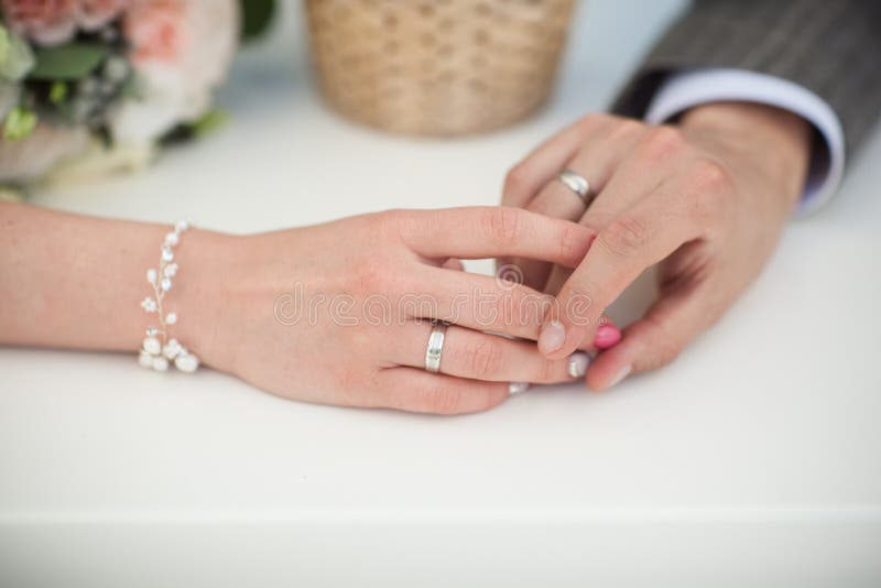 Hands of Husband and Wife with Rings Stoc