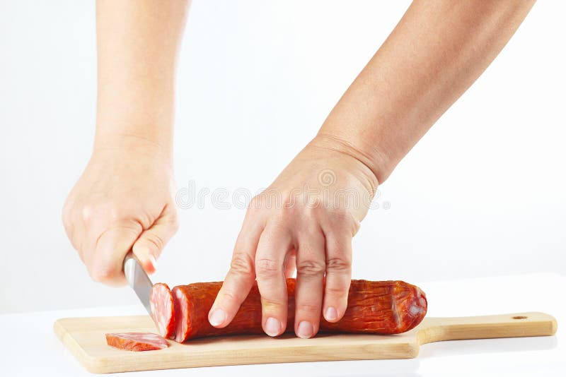 Hands with a Knife Sliced Salami on Cutting Board Stock Image Image