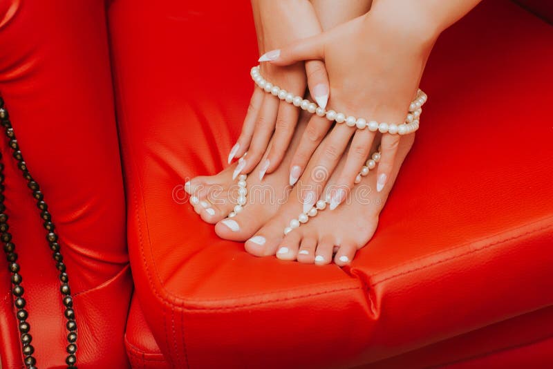 Legs And Hands Close Up. Creative Gel Polish Red Pedicure And Stock