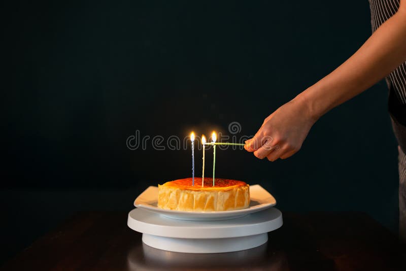 Hands Lit Candles on Birthday Cake in Black Background. Stock Photo - Image  of anniversary, hand: 184339912