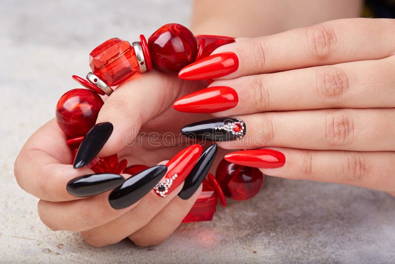 Premium Photo | A red and black nail art design with a silver border