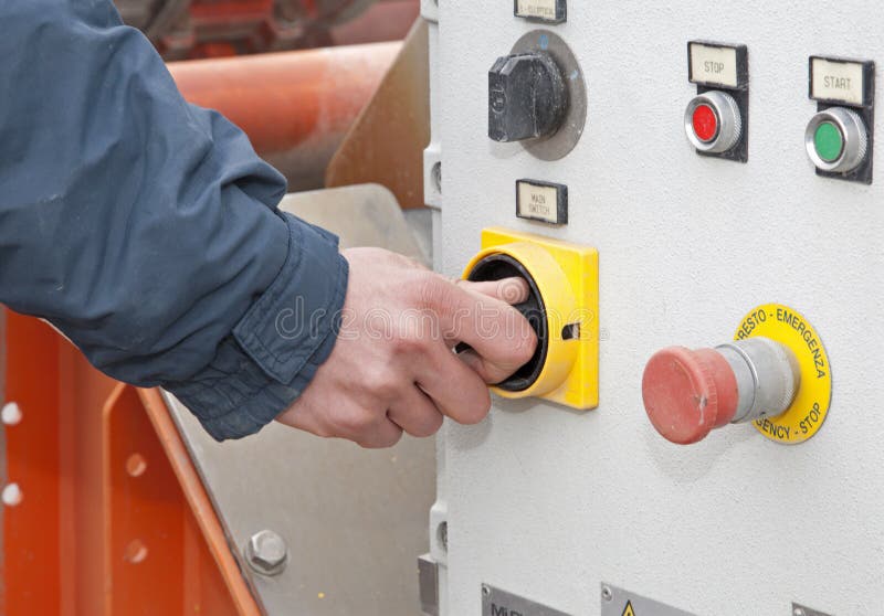 Hands of man at button - industry stock image