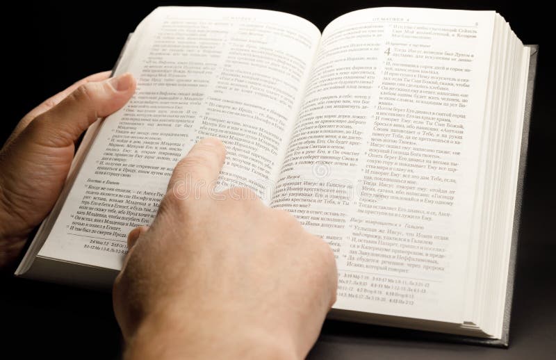 The Hands of a Man Holding the Bible while Studying it Stock Image ...