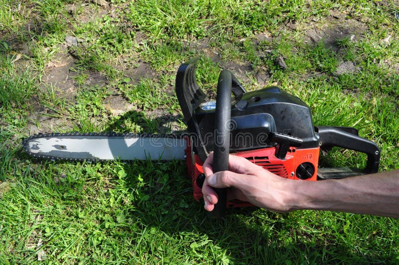 Hands Of A Man Holding A Chainsaw On A Background Stock Image Image