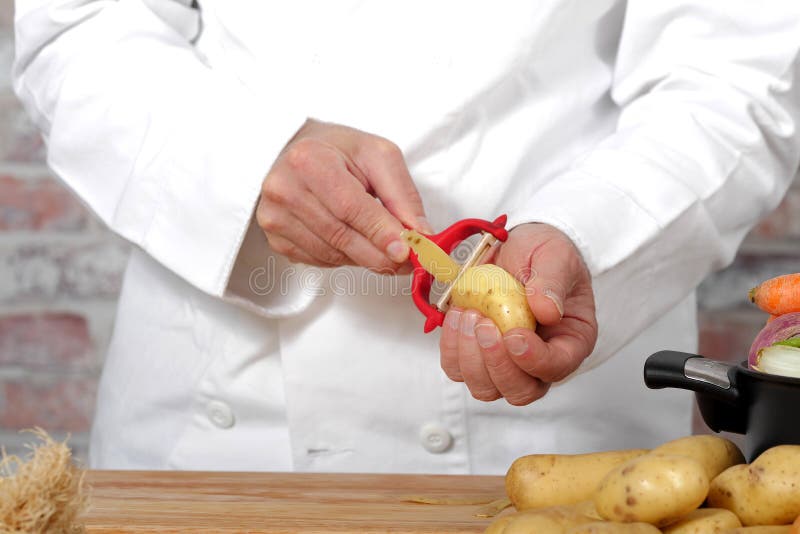 Hands peeling potato stock photo. Image of staple, cooking 16742654