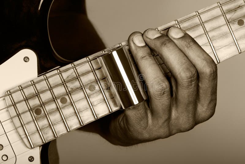 Hands of man playing electric guitar