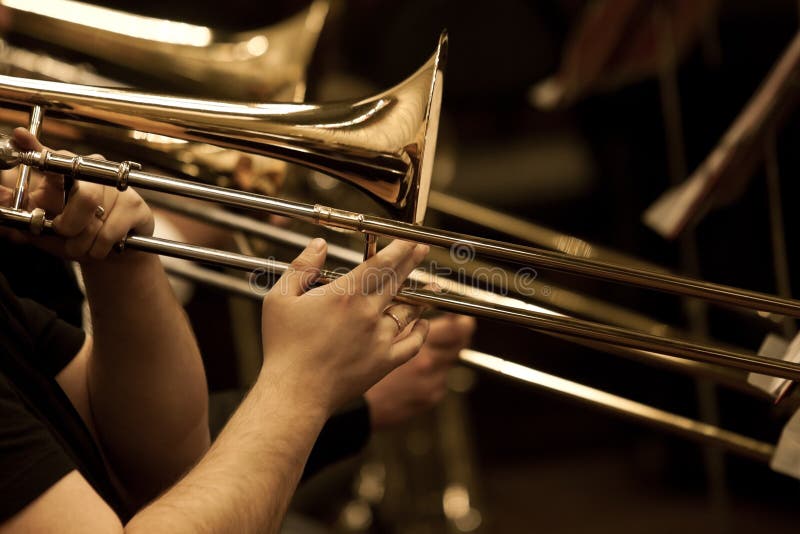Hands of man playing the trombone royalty free stock photography