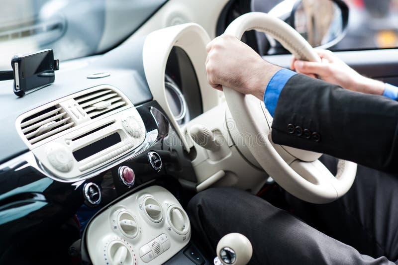 Hands of a man on steering wheel of a car royalty free stock photos