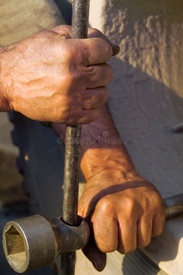 The hands of men working with a lever