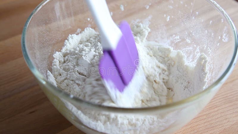 Hands mixing dough