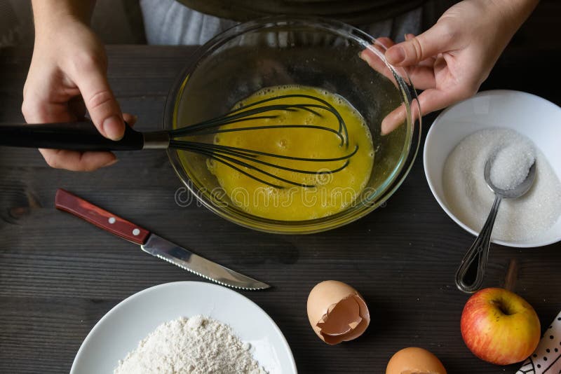 Hands mixing eggs in bowl stock photo. Image of dish 88900228