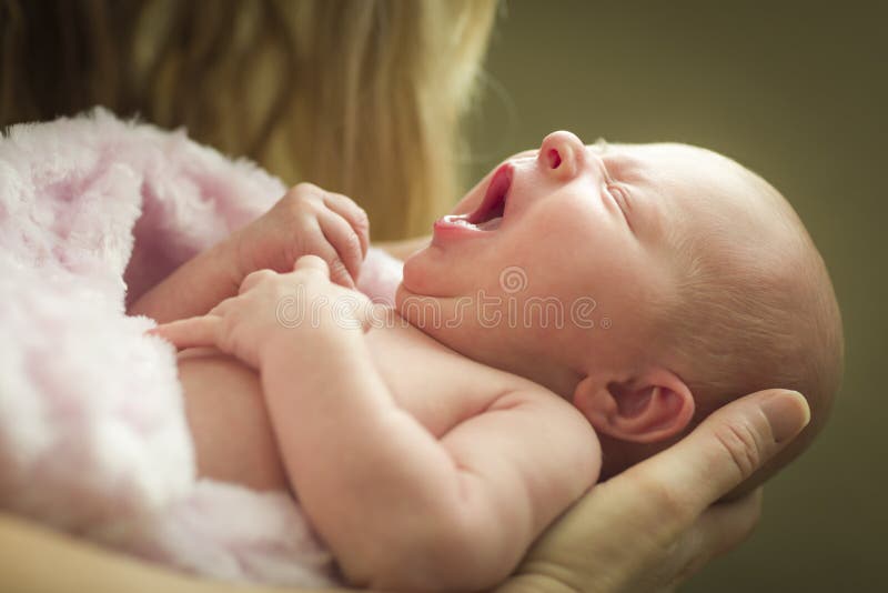 Hands of Mother Holding Her Newborn Baby Girl