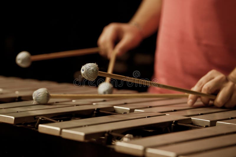 Hands of the man playing the vibraphone in dark colors. Hands of the man playing the vibraphone in dark colors