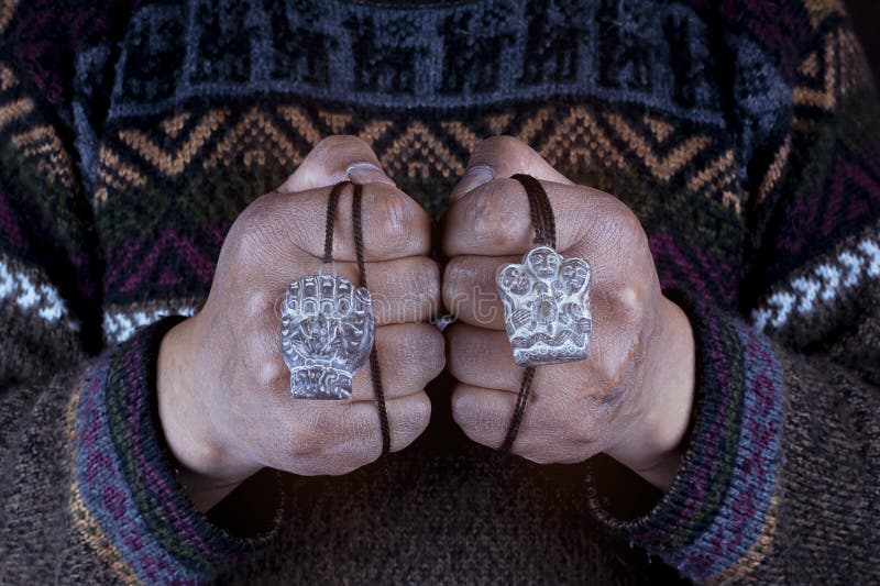 The hands of the native hold in their hands, the symbol of the family union, and the fist of strength. royalty free stock photo
