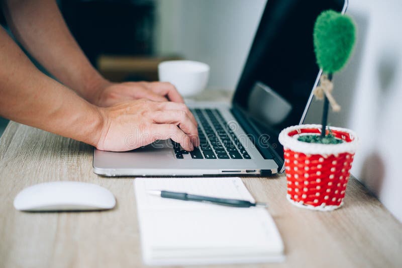 Hands and notebooks working in an office