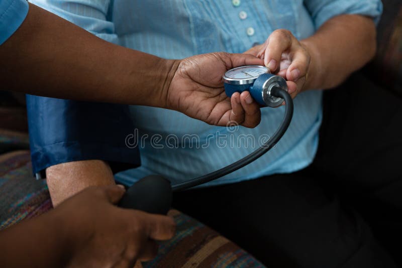 Hands of nurse examining patient in nursing home