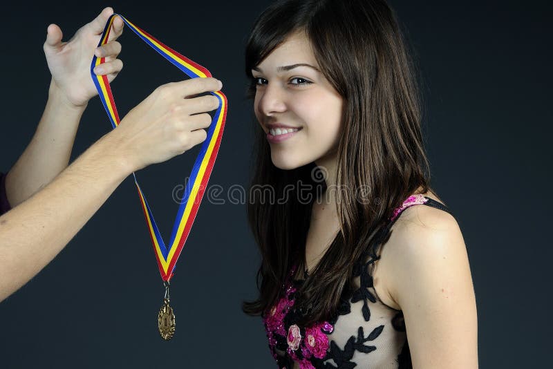 Hands offering golden medal