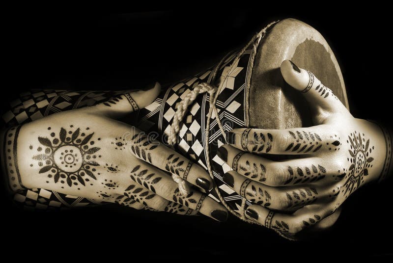 Hands with oriental tattoo and drum