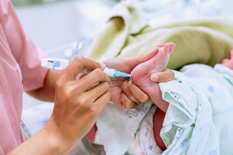 Hands of pediatric nurse holding and using Accu-Chek Fastclix