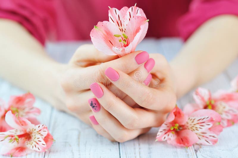 Hands with pink color nails manicure