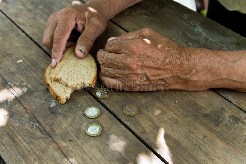 Hands the poor old man& x27;s, piece of bread and change, pennies on